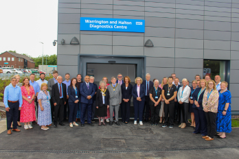 WHH Chief Executive Nikhil Khashu with staff and dignitaries, including local MPs and the Mayor of Halton, at the opening of Warrington and Halton Diagnostics Centre at the Captain Sir Tom Moore Building, Halton Hospital 