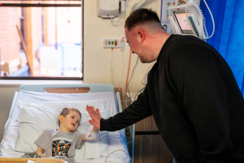 Luke Littler with a patient