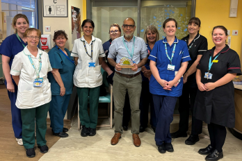 Photo of The Forget Me Not Unit Team with the award